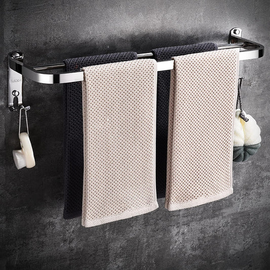  Stainless steel towel racks mounted on a white bathroom wall.